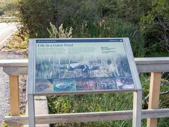 A metal framed National Park Service sign with the title text,