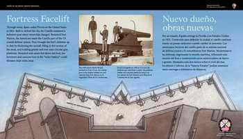 This panel is divided into 3 horizontal sections. The top third is a light blue sky; the middle section, brown earth; the bottom section, white text in English and Spanish against a blue background:  Weapons of War. Touring the fort, you will see 3 types of artillery: mortars, howitzers, and cannons. Attackers as well as defenders had access to many types of weaponry. Each one had its own strengths and weaknesses. A CANNON was best at shooting far, a MORTAR used exploding projectiles, and a HOWITZER was a mix of the 2. Battles to conquer a fort often last a long time. Choosing the right artillery could mean the difference between victory and defeat.  End of Text  On the top, against the light blue sky are 3 small circles. In each circle is a photograph of a piece of artillery. In the left circle, a bronze green and brown squat mortar gun tips upward at a left angle. In the center circle, a grey, stocky horizontal howitzer iron gun is supported on a low grey wedge. To the right, a bronze, green and brown cannon, its barrel tipped slightly upward, is set in a dark gray wooden gun carriage.  Below each photo is a small brown illustration of the corresponding gun firing. A brown dotted, arcing line, runs from the mouth of each piece of artillery to a spot at the left side of the panel to show the trajectory of the shot from each gun. The mortar and howitzer lines end in an illustration of an exploding shell,  and the cannon line ends with an illustration of a cannonball.   Below, at the left, against the light brown earth, black text in English and Spanish reads:   Fire! Exploding shells were most effective when fired from mortars and howitzers while solid shot (cannonballs) were best when used with cannons.  End of Text  To the right, and below each artillery illustration, 3 light tan rectangular boxes with black text in English and Spanish.  Below the mortar :  â€¢ Shortest barrel â€¢ High, lobbing arc reaches targets behind walls and other barriers â€¢ Often used to fire on a besieged town â€¢   End of Text  To the right, below the howitzer:  â€¢ Hybrid gun with a mid-length barrel â€¢ Medium to high angle, adjusted to increase or decrease range â€¢ Combines cannon mobility with mortar firepower  End of Text  To the right, below the cannon:  â€¢ Longest barrel â€¢ Relatively flat trajectory â€¢ Destroys buildings, walls, and other obstacles  End of Text  Beyond the panel are 8 howitzers of varying sizes set on low concrete bases. All point towards the fortâ€™s seawall at the right. The first 3 are mortars; next, are 3 howitzers; and the last 2 are long, slender cannons. To the left of the artillery is the moat and the fortâ€™s slanted, dark gray bastion walls.  [End of message]