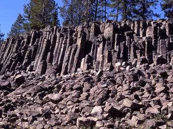 A wall of hexagonal rock forms a cliff.