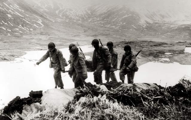 US soldiers carrying a casualty during the battle to recapture Attu from the Japanese in May 1943. US soldiers carrying a casualty during the battle to recapture Attu from the Japanese in May 1943.
