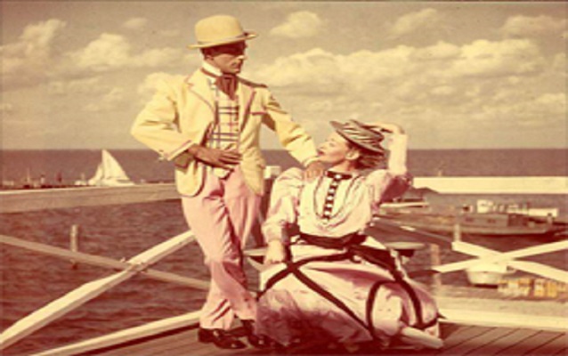 Man standing next to woman near the beach.