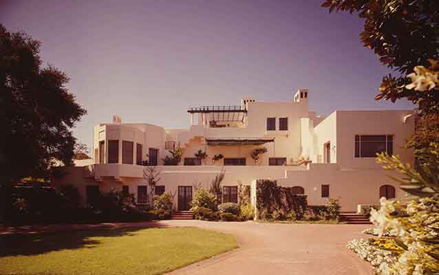 A huge international style house resembles beige blocks piled up. A huge international style house resembles beige blocks piled up.