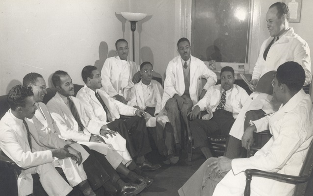 Dr. Charles Drew (top right) talks to a group of young doctors 