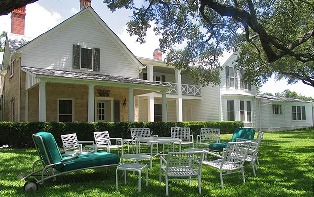 Lawn chairs sit in a circle in the front yard of the Texas White House. Lawn chairs sit in a circle in the front yard of the Texas White House.