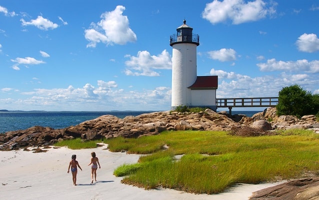 Children walk the beach below Annisquam Lighthouse Children walk the beach below Annisquam Lighthouse