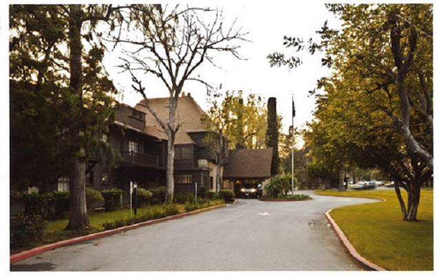 View of the outside of a building surrounded by trees.