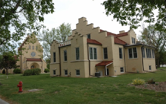 Outside of the building, yellow walls and red roofs.