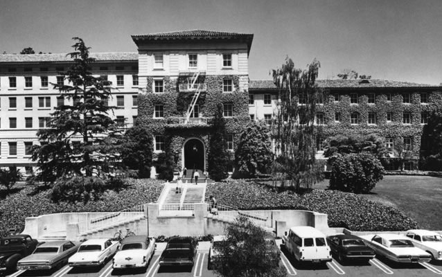 Exterior view of a large hospital building with ivy growing up the front.