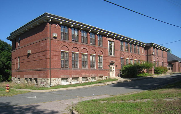 Exterior of a two-story red brick institutional building