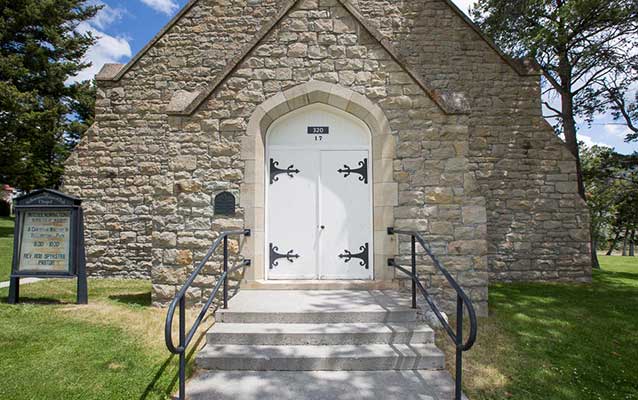 Front entrance to the stone chapel through twin white doors. Front entrance to the stone chapel through twin white doors.