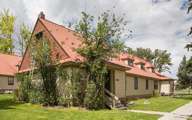 Tan wooden building with red tin roof. Tan wooden building with red tin roof.