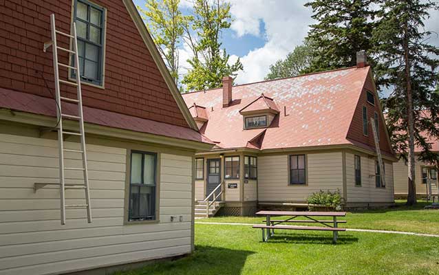 Tan wooden building with red tin roof. Tan wooden building with red tin roof.
