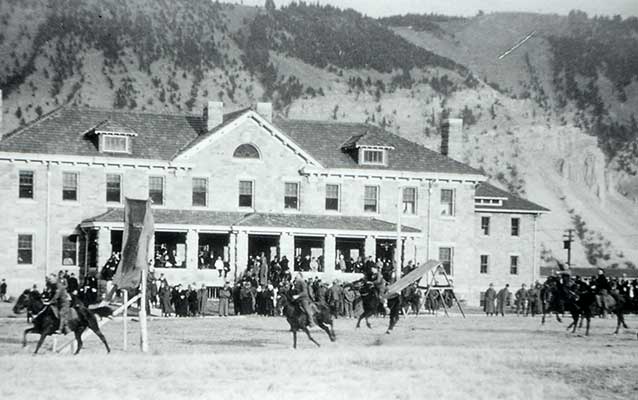 Soldiers performing horse drills on the parade grounds in front of the Bachelor Officers' Quarters. Soldiers performing horse drills on the parade grounds in front of the Bachelor Officers' Quarters.