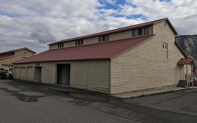 Tan wooden building with red tin roof. Tan wooden building with red tin roof.