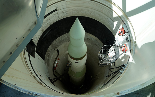 View down into a circular missile silo with a missile positioned in the middle View down into a circular missile silo with a missile positioned in the middle