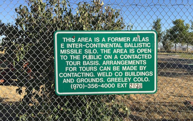 Wire fence with a green sign