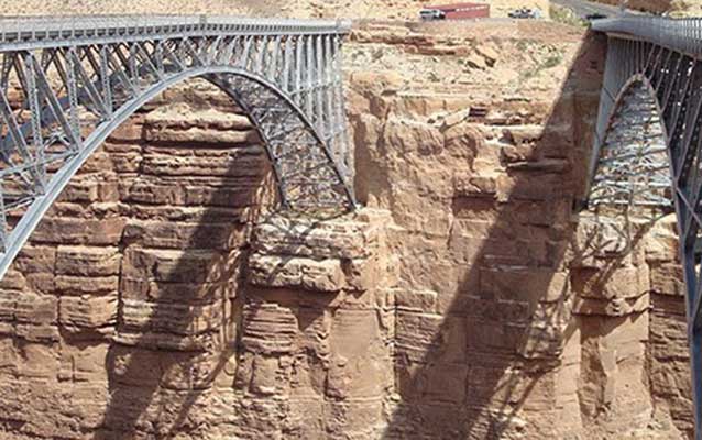 two steel arches span a desert canyon two steel arches span a desert canyon