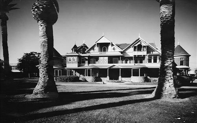 Black and white photo of a big mansion 