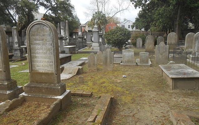 Cemetery with headstones in foreground and background 