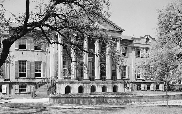 Black and white photo of library with Greco-Roman style columns. 