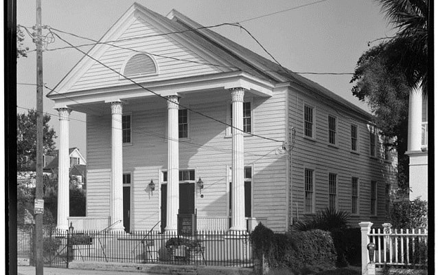 Black and white gabled white church.