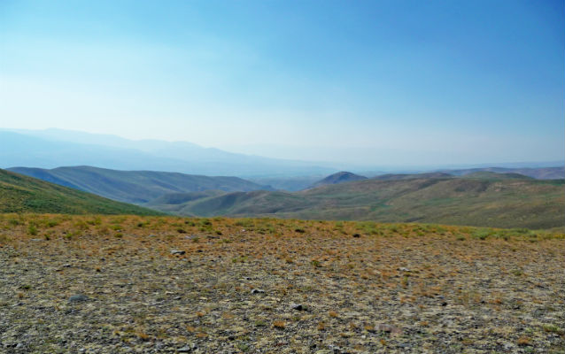 Wide open space with mountains in the background Wide open space with mountains in the background