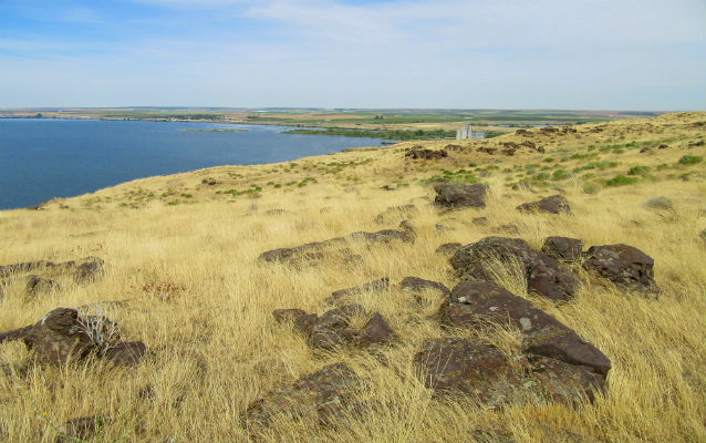 Rocky knoll with river in background Rocky knoll with river in background