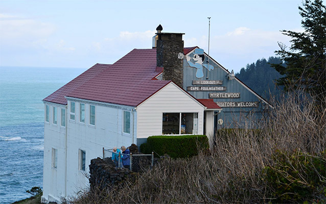 Building overlooking ocean with advertising sign on side of building