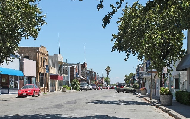 Streetscape of colorful one and two-story businesses. 