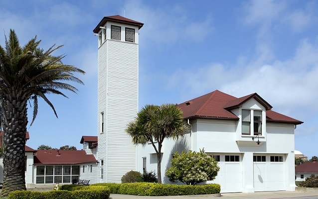 Two-story white building with tall white tower. Two-story white building with tall white tower.