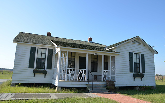 Five single story room white house with covered porch