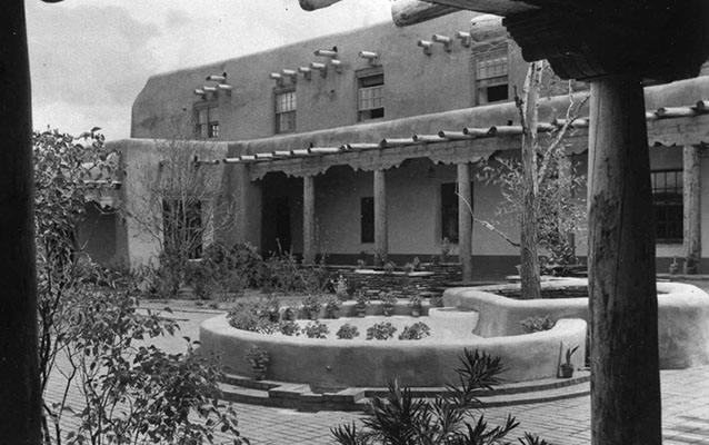 Historic photo of stucco building and courtyard