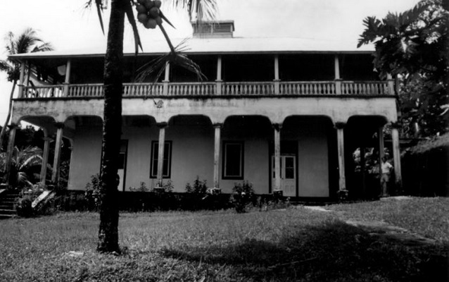 Two-story school made of concrete with long porches on both levels. Courtesy NPS. 