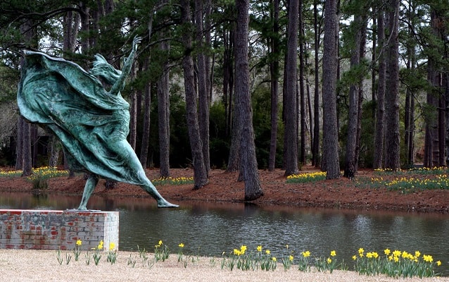 Brookgreen gardens with oxidized bronze statue in foreground, By anoldent, CC BY-SA 2.0.
