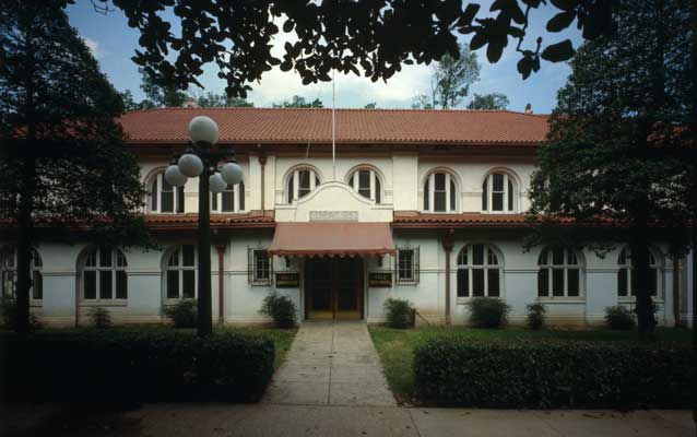 the front entrance of the hale bathhouses with red roof, arched windows, central sidewalk the front entrance of the hale bathhouses with red roof, arched windows, central sidewalk