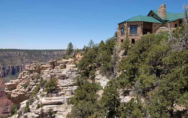 grand canyon on left with hotel perched upon its edge on the right surrounded by pine trees grand canyon on left with hotel perched upon its edge on the right surrounded by pine trees