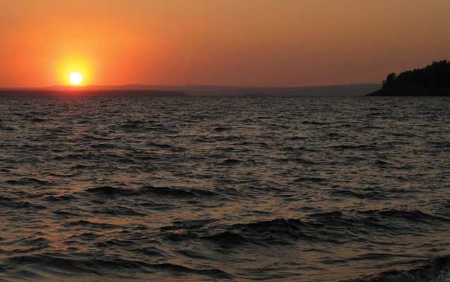 Sun rising over the waters of Yellowstone Lake