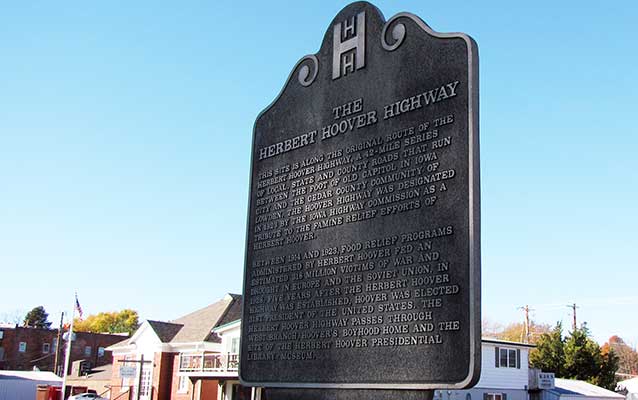 A bronze historical marker commemorates a historic auto route. A bronze historical marker commemorates a historic auto route.