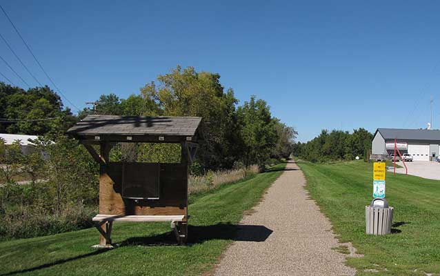 A bronze historical marker commemorates the route of a historic auto trail. A bronze historical marker commemorates the route of a historic auto trail.