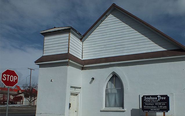 a one‐story, rectangular, front gable building on a street corner