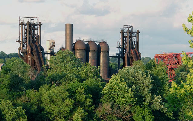 Blast furnace towers among trees