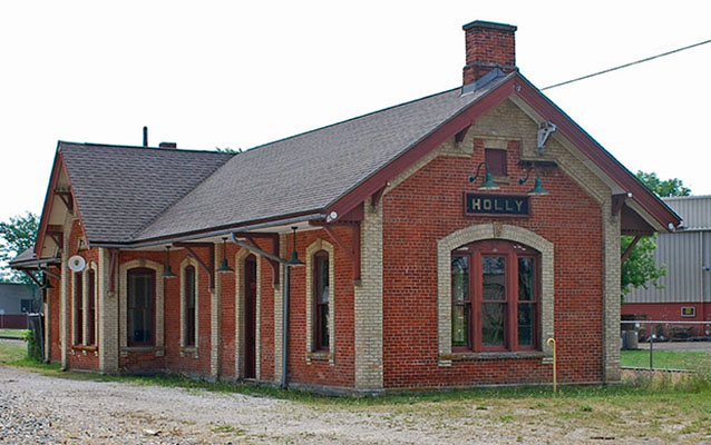 Exterior of a one-story red brick railroad depot