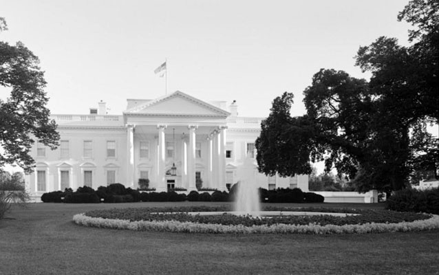 white house with fountain and flowers