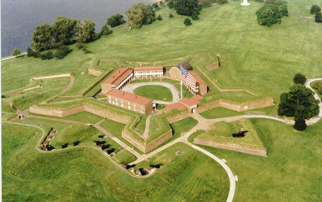 A star-shaped masonry fort at the edge of a body of water.