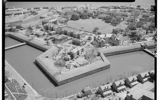 A black and white photo of a star-shaped brick fort.