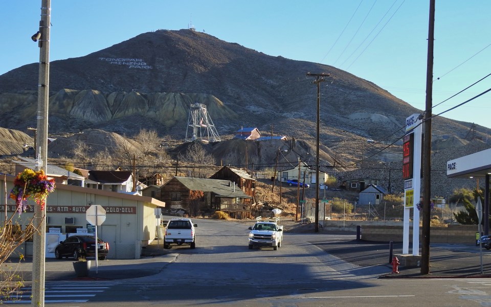 People and buildings with mountain in background.