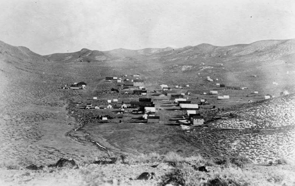 Buildings scattered in desert valley.