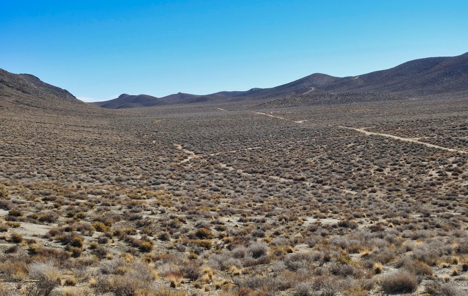 Buildings scattered in desert valley.