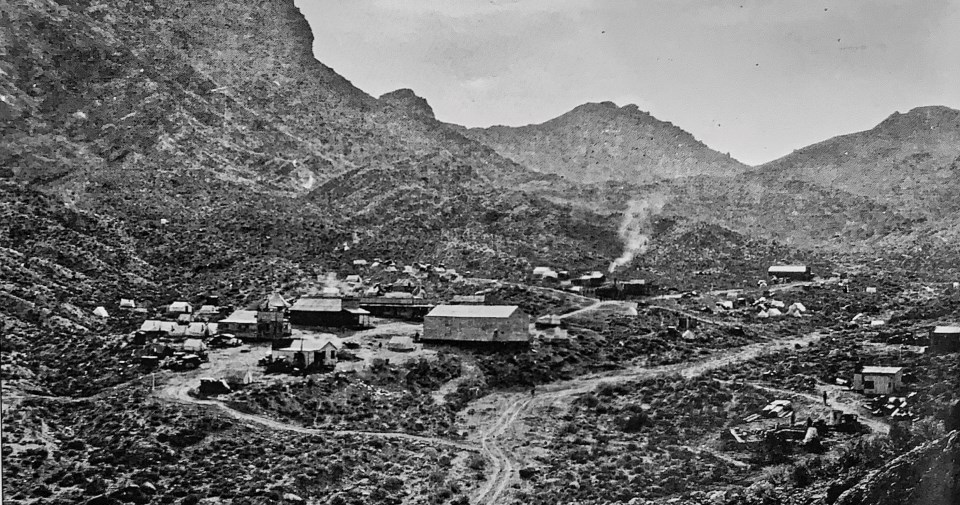 Old buildings in desert valley.