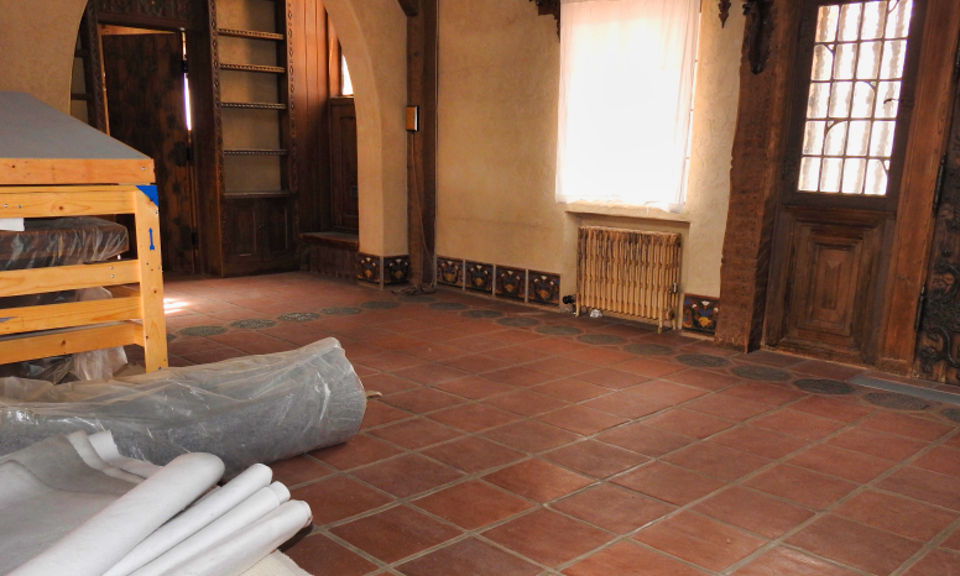 Two men and a woman sit in a furnished room.